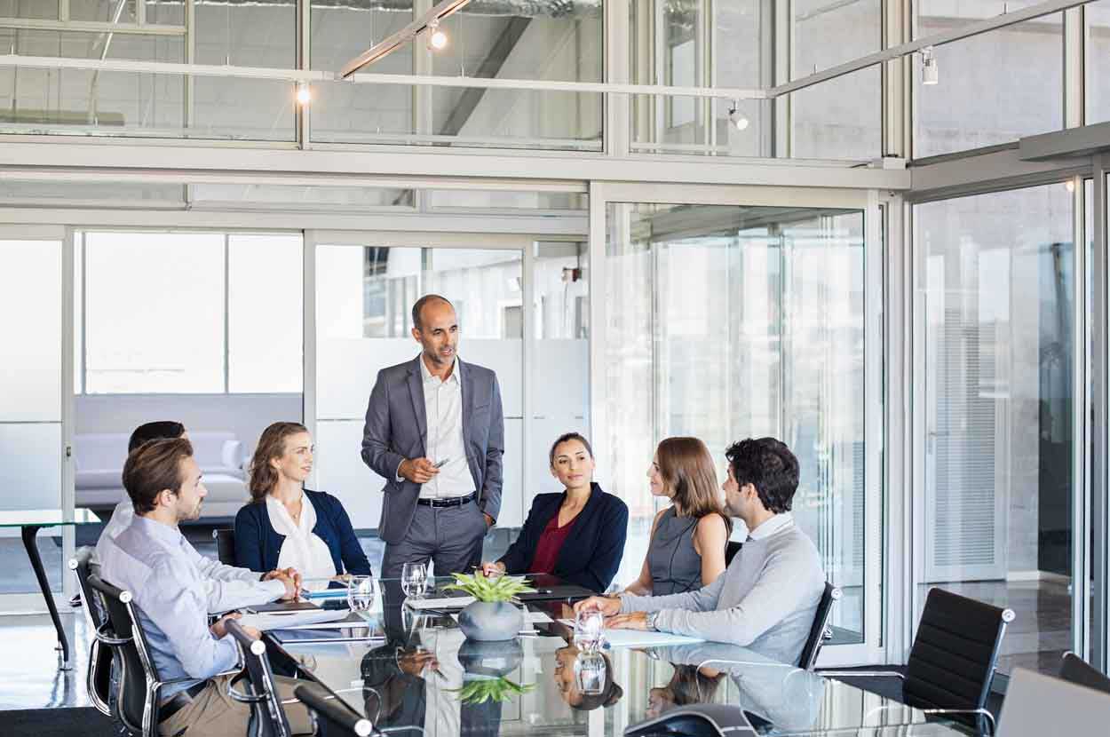 Group of people sitting around a conference table