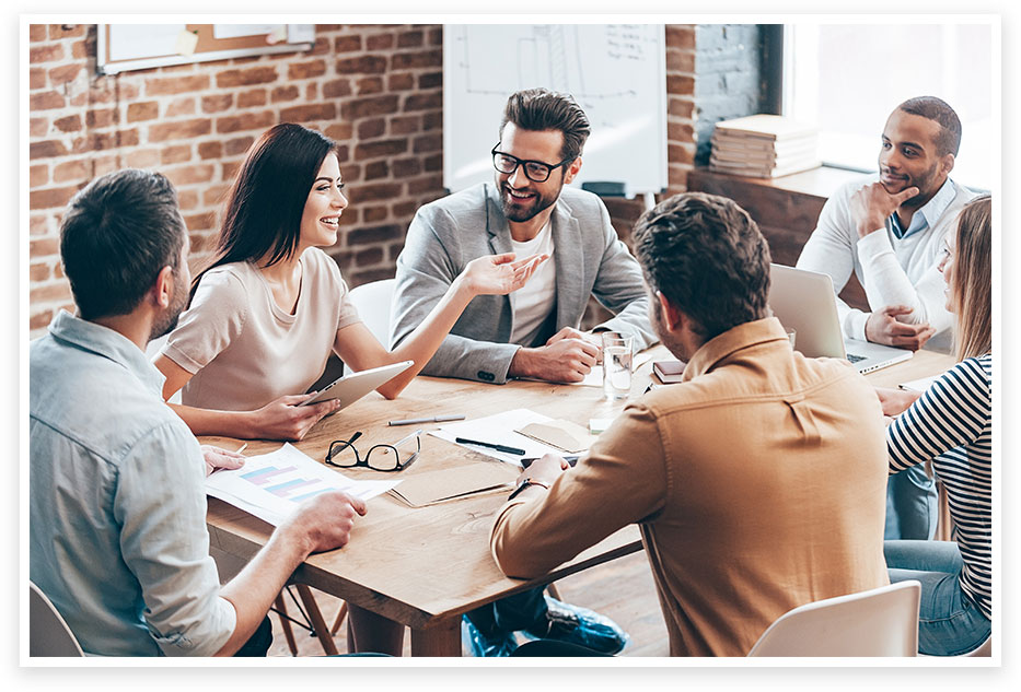 Group of women and men around a table discussing resource planning